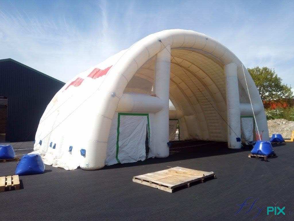 Half-moon tunnel, large inflatable military hangar, 2 doors, main access, service door, with signage, exits and emergency services.