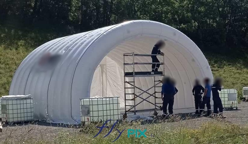 Installation, assembly and installation of an inflatable tent, half-moon tunnel military hangar, for the army, dedicated to the storage of military equipment and materials, war machines, military aircraft, tanks, or military vehicles and military machinery.