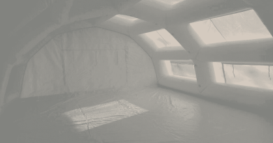 An interior view of the inflatable first aid station shelter manufactured for the SAMU (Emergency Medical Service) of the Evreux Hospital Center , providing a very large space, a very large surface area, and a very large usable work volume for medical staff and doctors. A PVC-coated tarpaulin floor creates a clean, hygienic, and moisture-free first aid area. The tarpaulin also provides better thermal insulation and protects against moisture rising from the ground. The usable interior space is ideal for accommodating a significant number of patients and can be furnished with folding medical beds, desks, etc. – Copyright Vivien LAÏLLE / FlyPix – All rights reserved, reproduction prohibited.