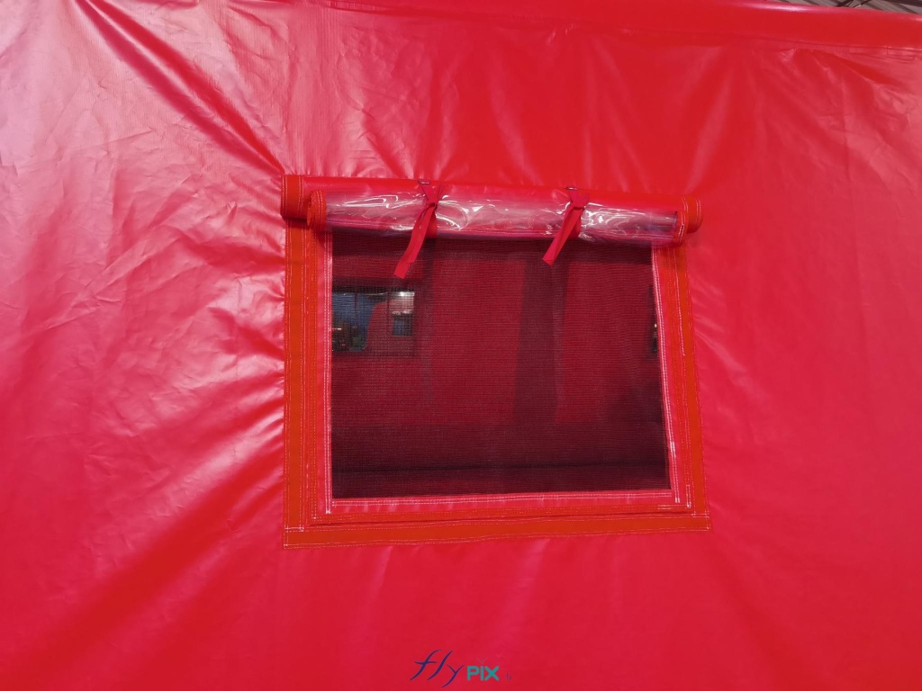 A photo showing a window of the inflatable first aid tent, with shutter, window and mosquito net. – Copyright Vivien LAÏLLE/FlyPix, all rights reserved, reproduction prohibited.
